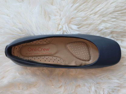 Navy blue shoe with 'OnliCrew' branding on a white fluffy surface